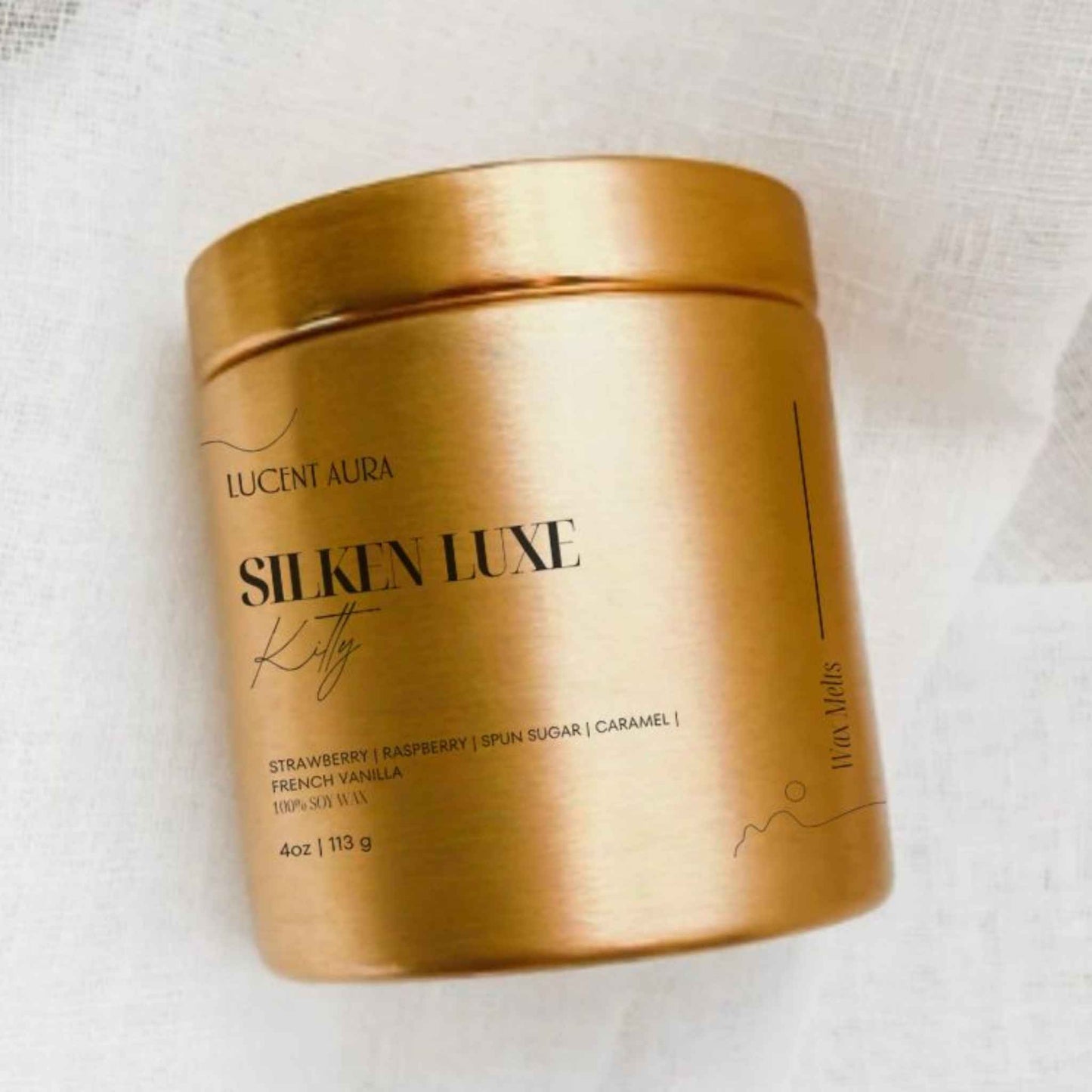 Gold container of Lucent Aura Silkin Luxe Kitty on a white background