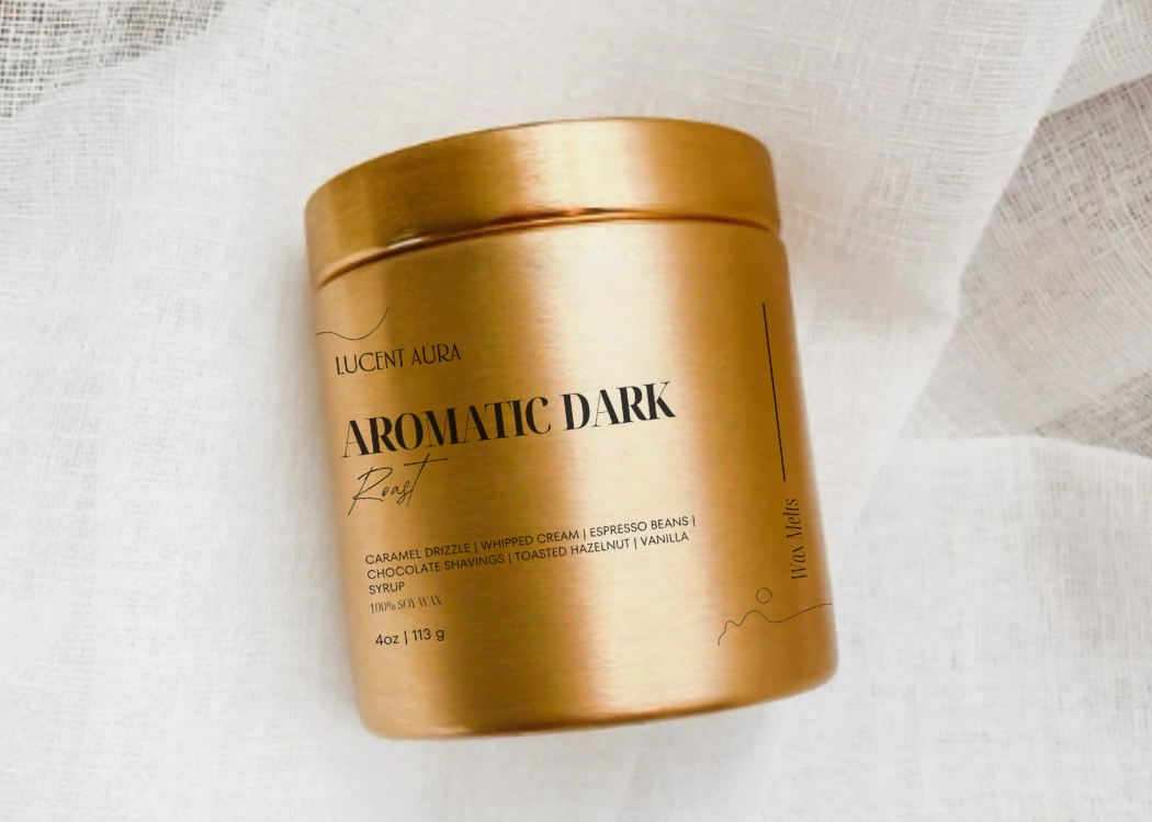 Gold container of Lucent Aura Aromatic Dark roast coffee on a light fabric background