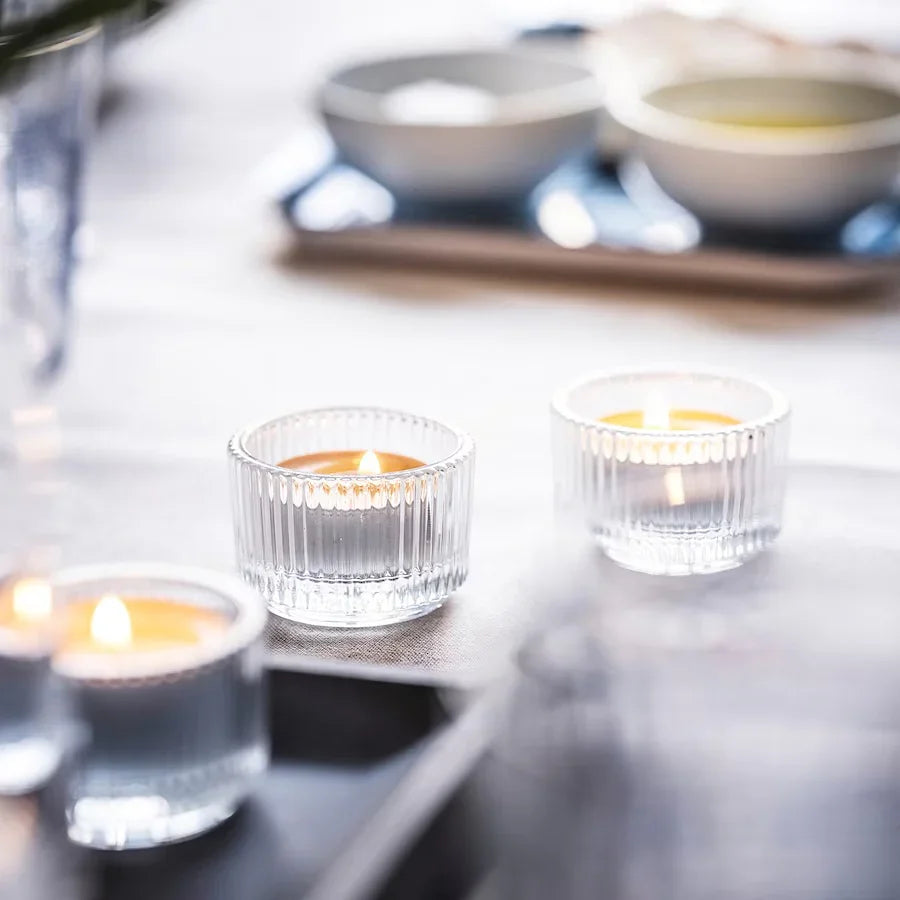 Ribbed glass tea-light holder with a blurred background