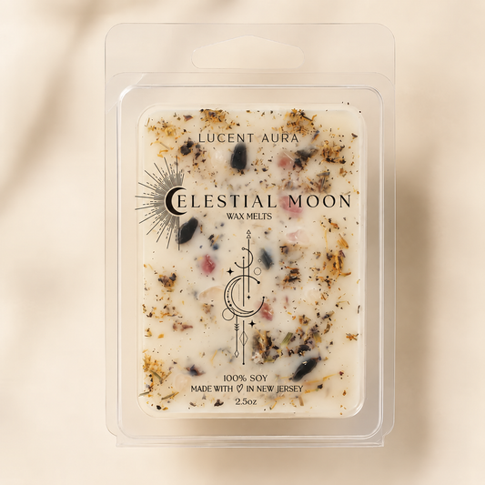A clear plastic clamshell package containing Lucent Aura Celestial Moon wax melts, with a cream-colored wax base speckled with botanicals and dark flecks, set against a warm beige background.