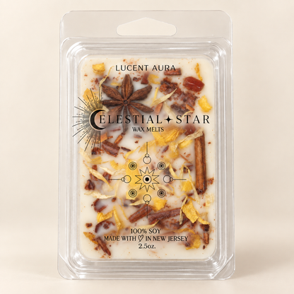 Celestial Star Wax Melts in a clear plastic clamshell package, featuring a white wax base with embedded botanicals like star anise, cinnamon, and dried citrus peels. The front label reads 'LUCENT AURA' and 'CELESTIAL STAR WAX MELTS'.
