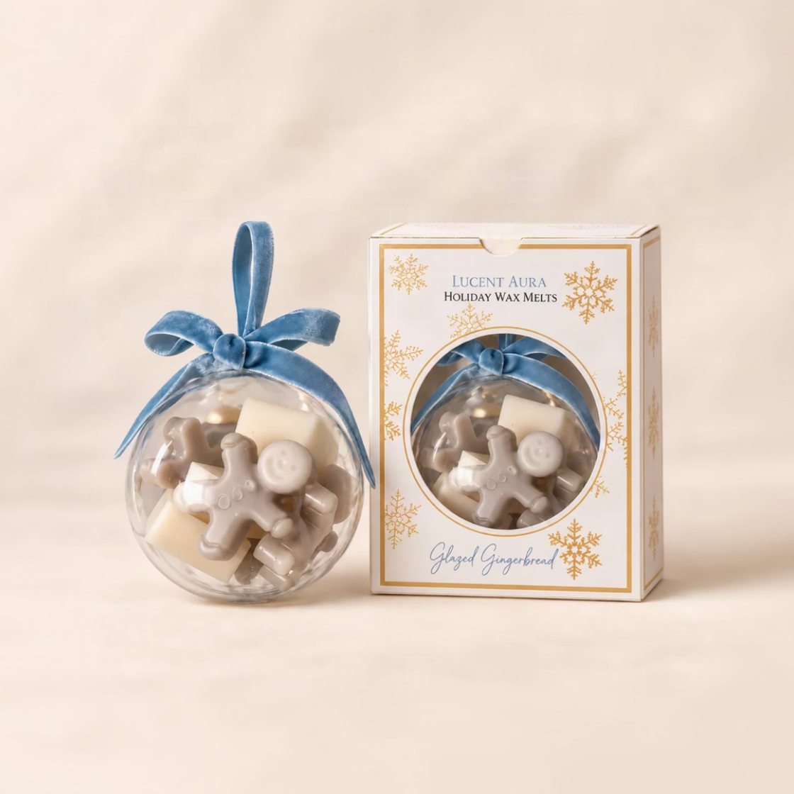 A clear glass ornament filled with holiday wax melts tied with a blue ribbon, shown next to its white and gold branded box labeled 'Lucent Aura Holiday Wax Melts Glazed Gingerbread'.