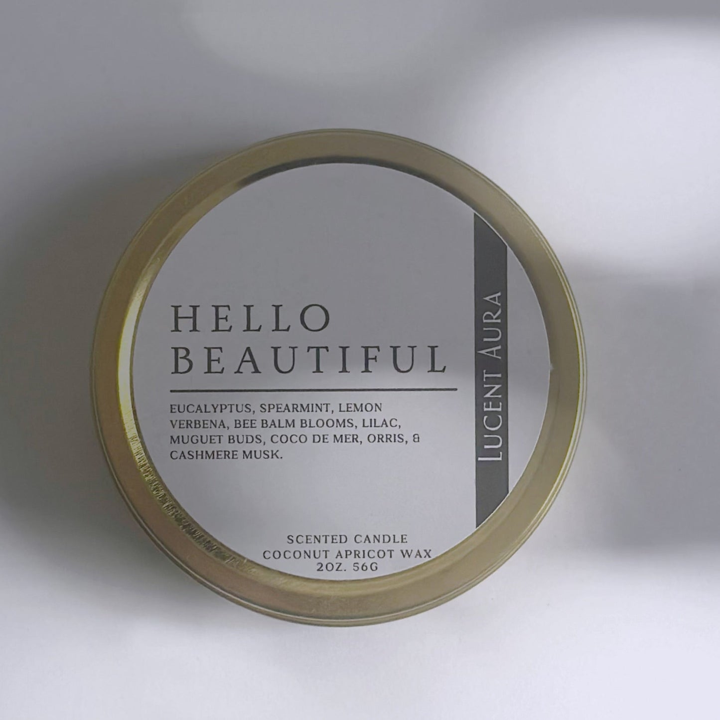 Candle jar labeled 'HELLO BEAUTIFUL' on a light background