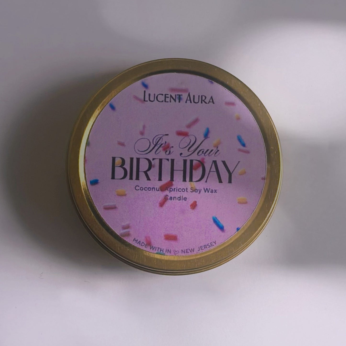 Candle tin with 'Happy Birthday' text on a white background