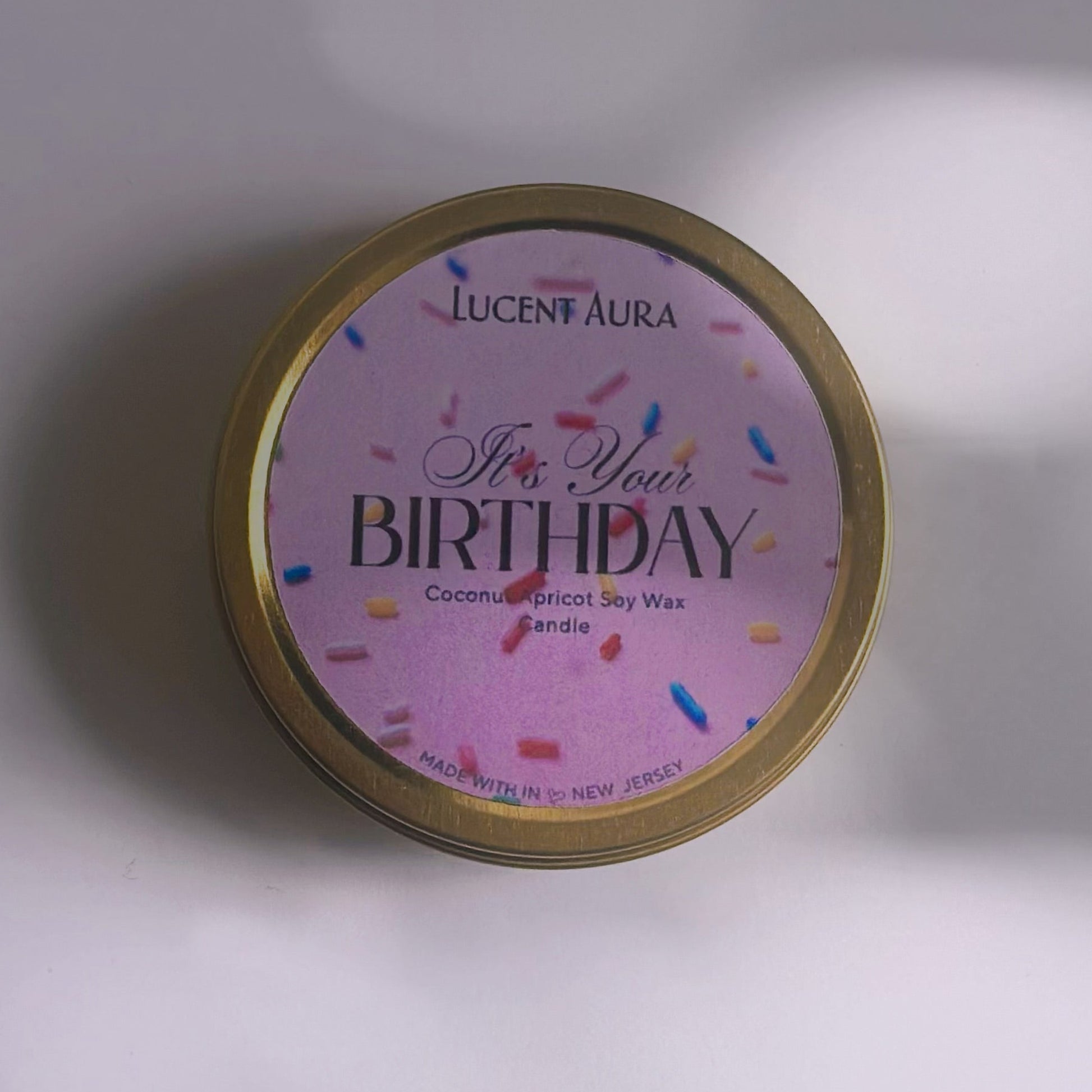 Candle tin with 'Happy Birthday' text on a white background