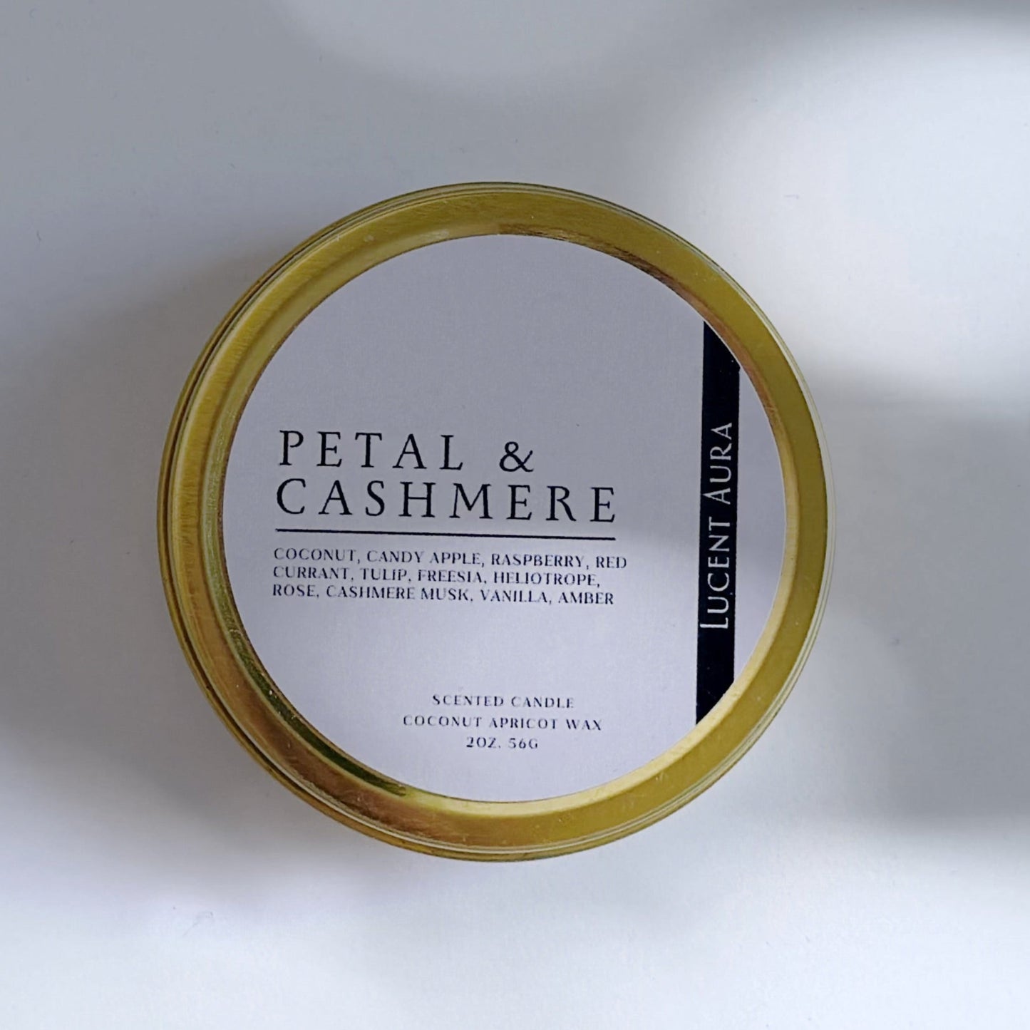 Candle jar labeled 'Petal & Cashmere' on a white background