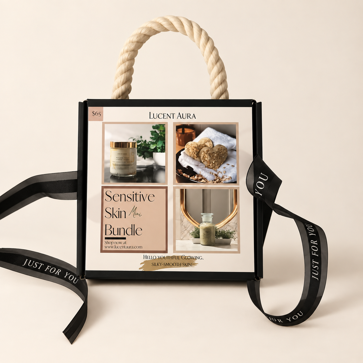 A square gift box for a Lucent Aura Sensitive Skin Bundle, featuring a cream rope handle, a black ribbon with gold lettering, and a front insert showing product photos and text.