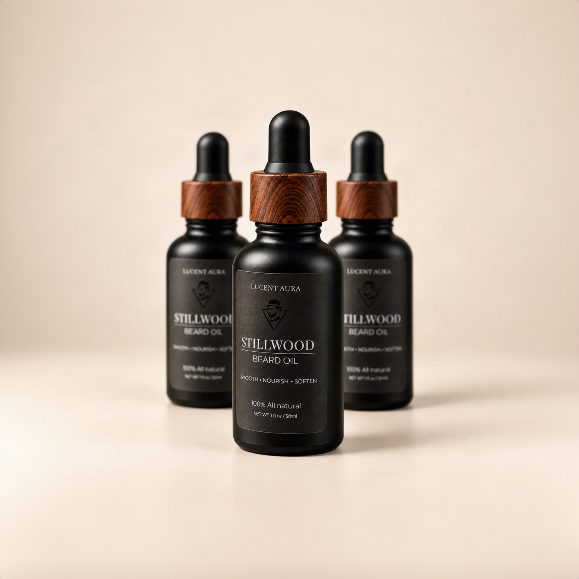 Three black glass dropper bottles of Lucent Aura Stillwood Beard Oil with dark wood caps, arranged in a row on a light beige background.