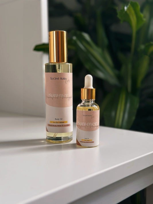 Lucent Aura body oil bottles displayed in soft natural light with greenery in the background.