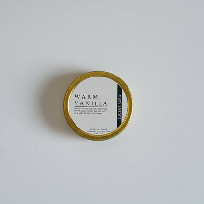  candle 'Warm Vanilla' on a white background in a gold tin