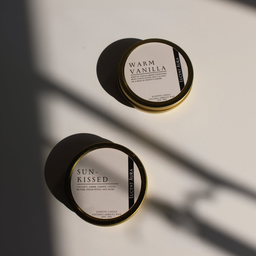 Two Lucent Aura candles, one labeled 'Warm Vanilla' and the other 'Sun-Kissed', on a light background.