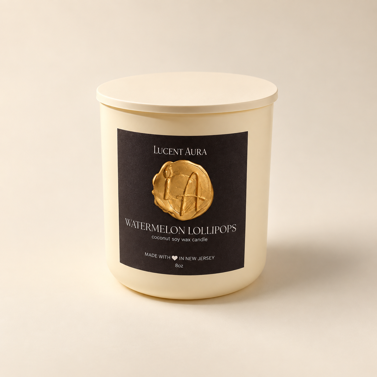 A cream-colored soy wax candle with a matching lid and a black label featuring a gold wax seal and the brand name 'Lucent Aura'.