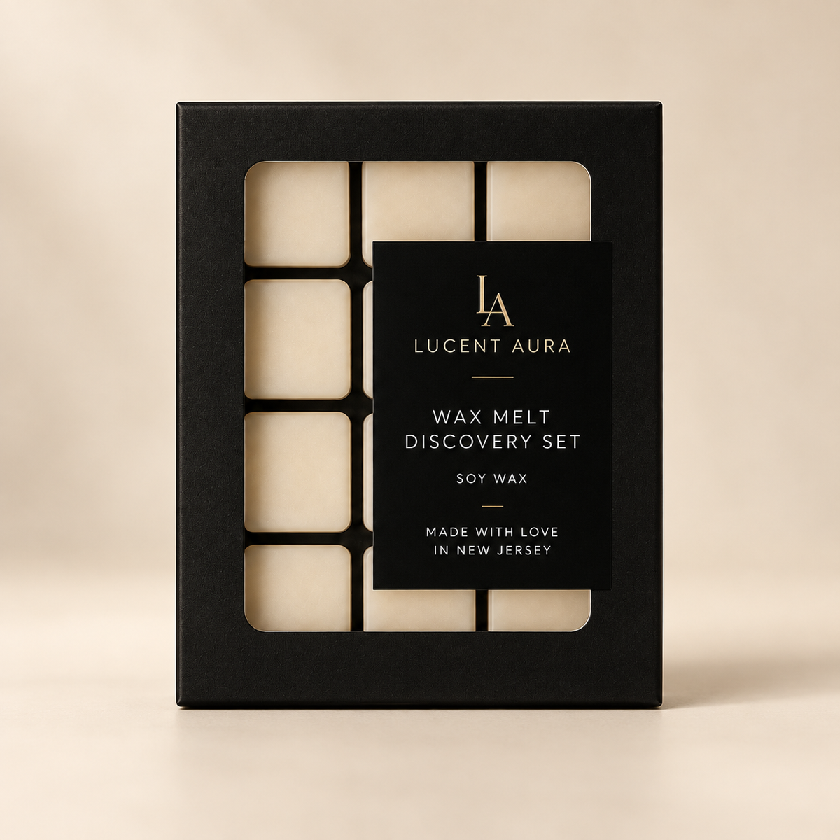 A black rectangular box for a Lucent Aura Wax Melt Discovery Set, showing six cream-colored wax melts through cutout sections on a warm beige background.