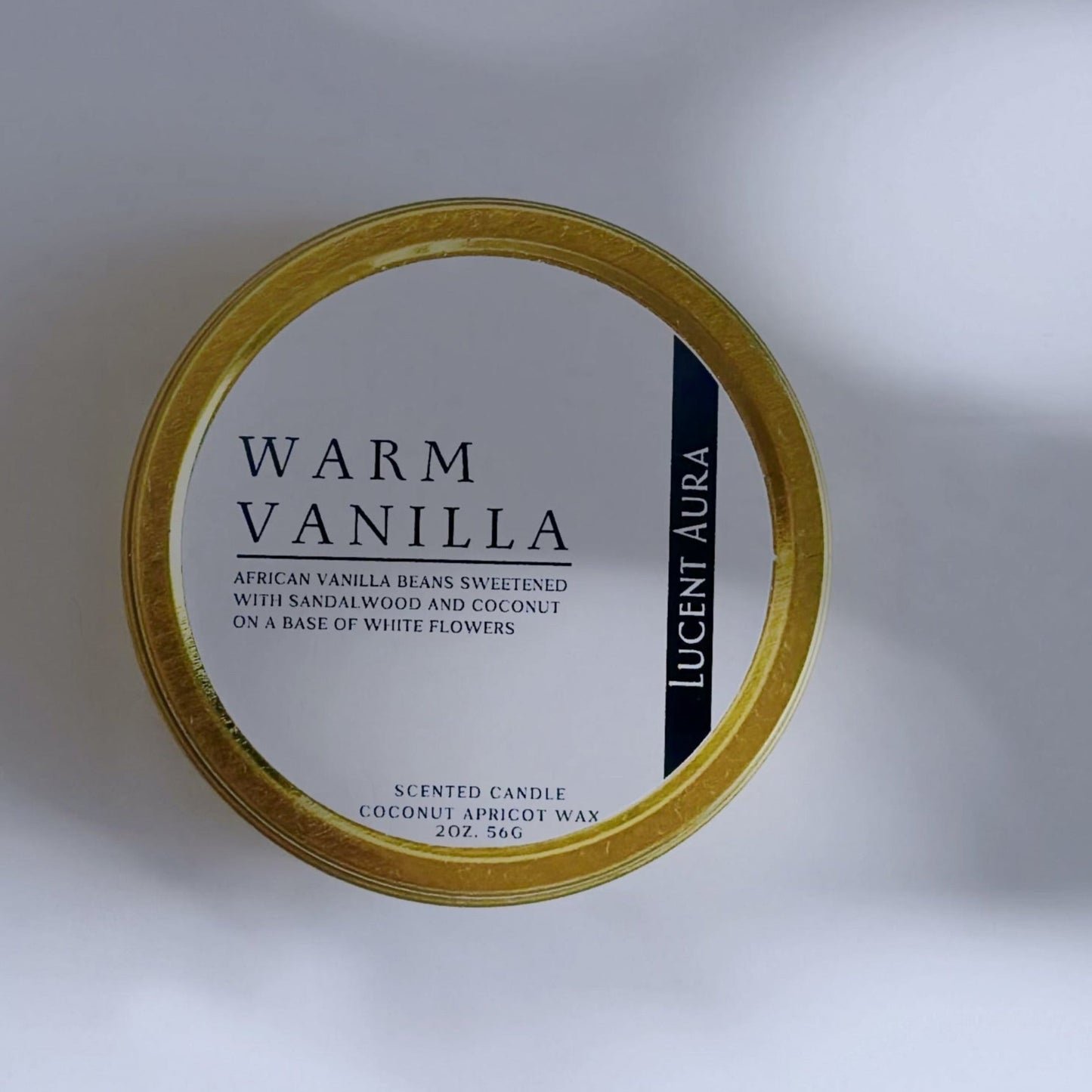 Candle container labeled 'Warm Vanilla' on a light background