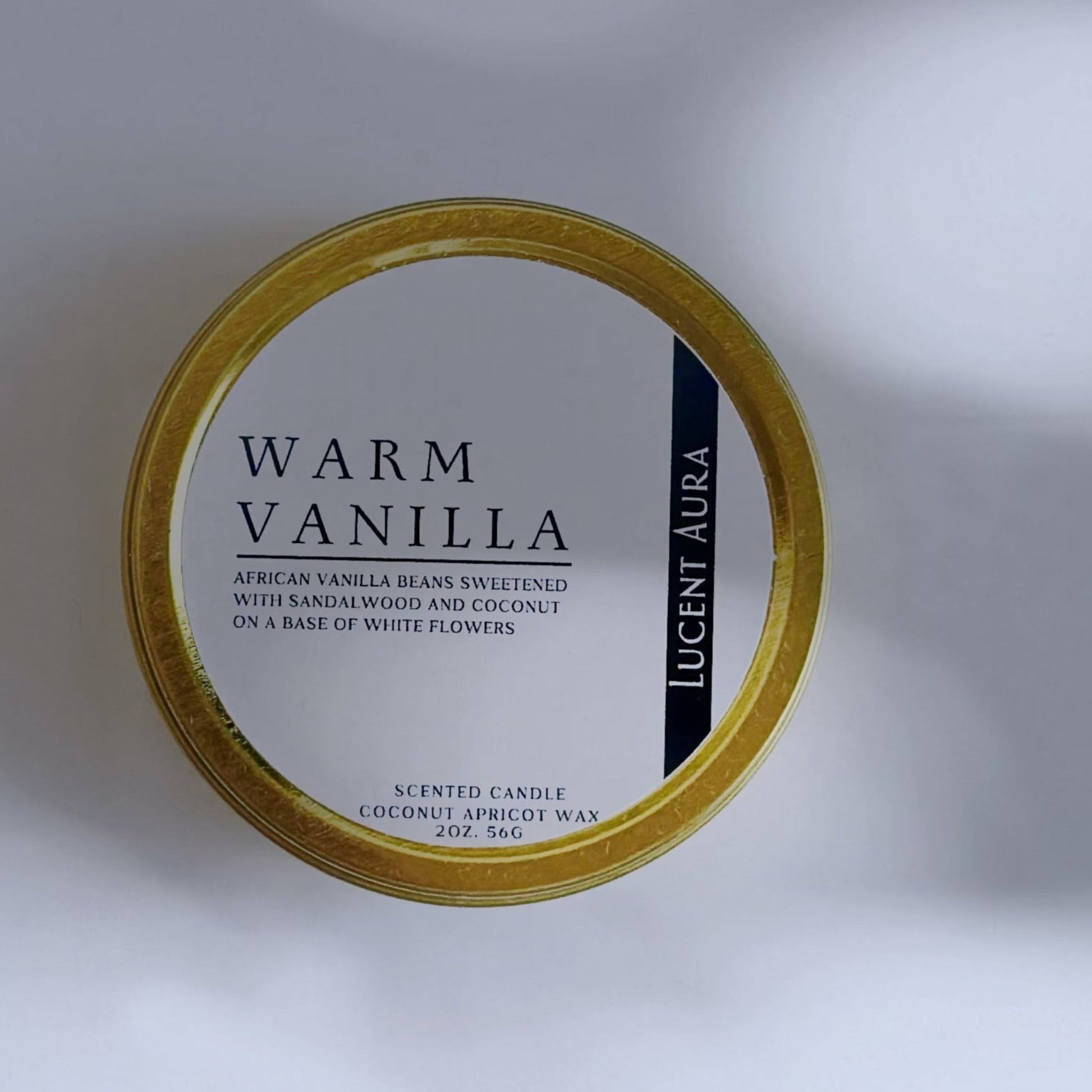 Candle container labeled 'Warm Vanilla' on a light background